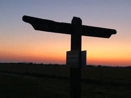 fingerpost against setting sun