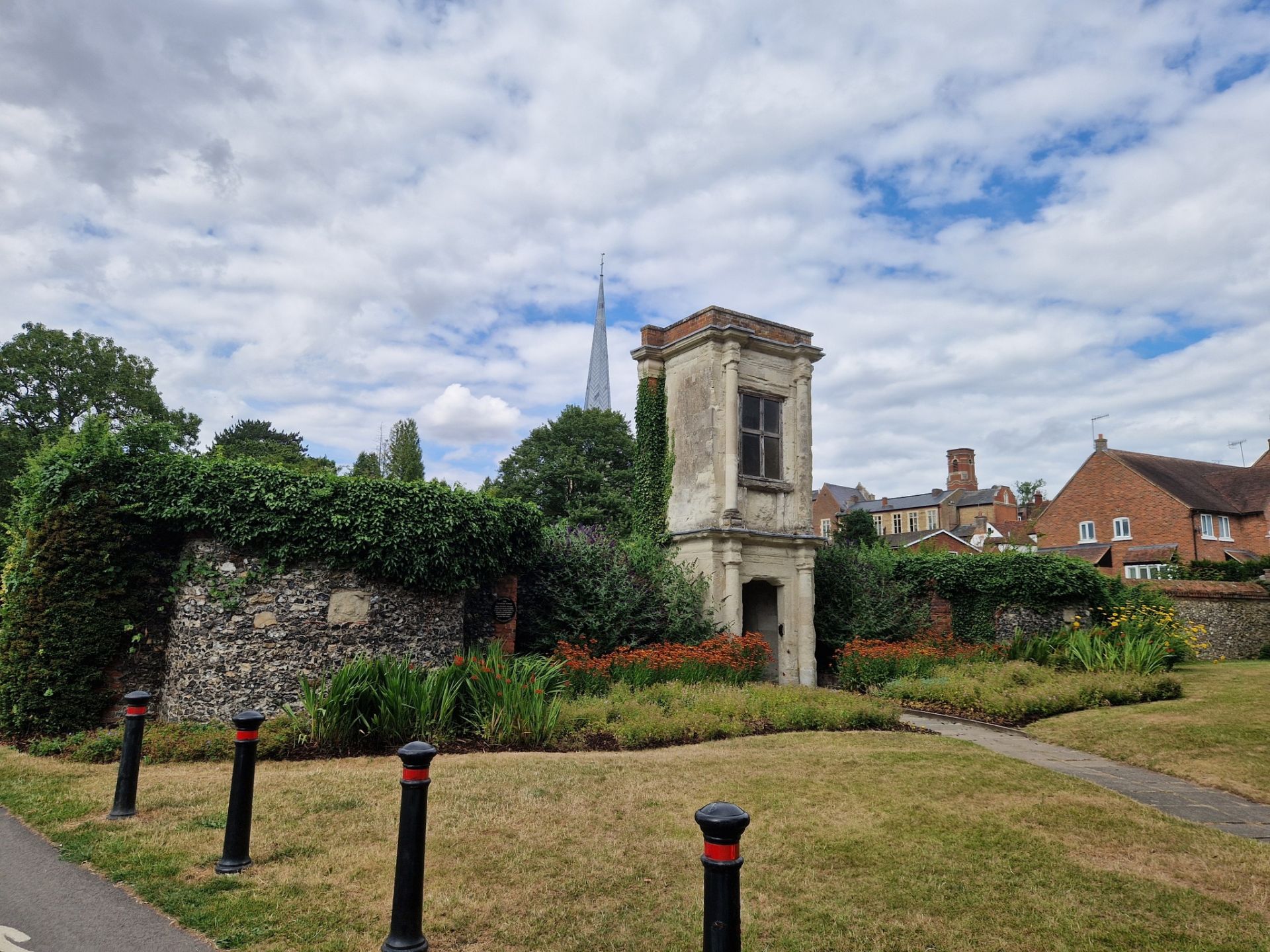 An old tower and wall by a park