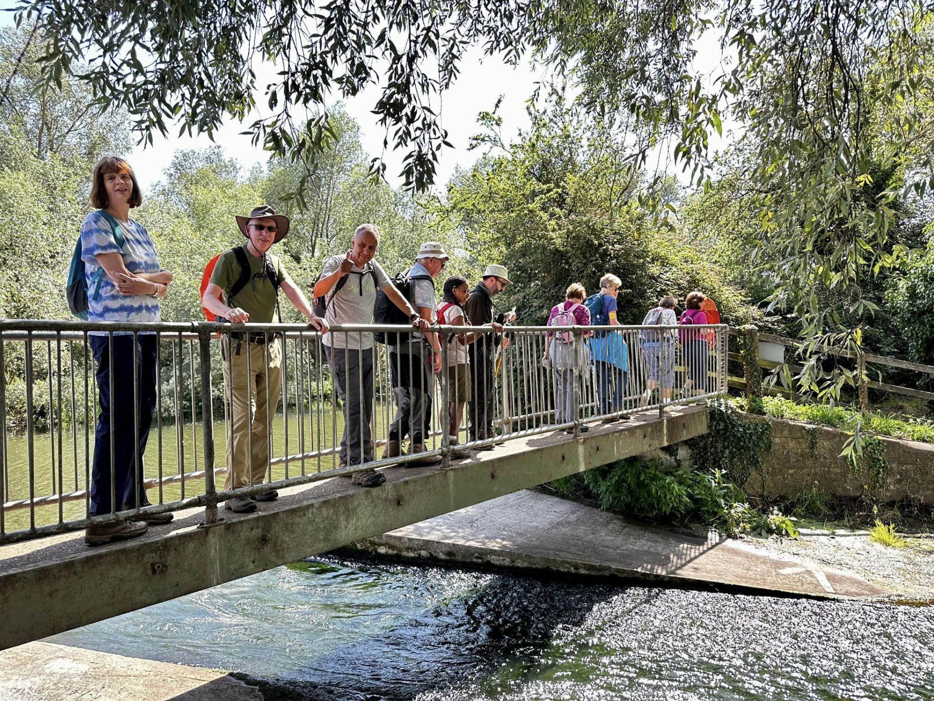 Ramblers on a bridge over a stream