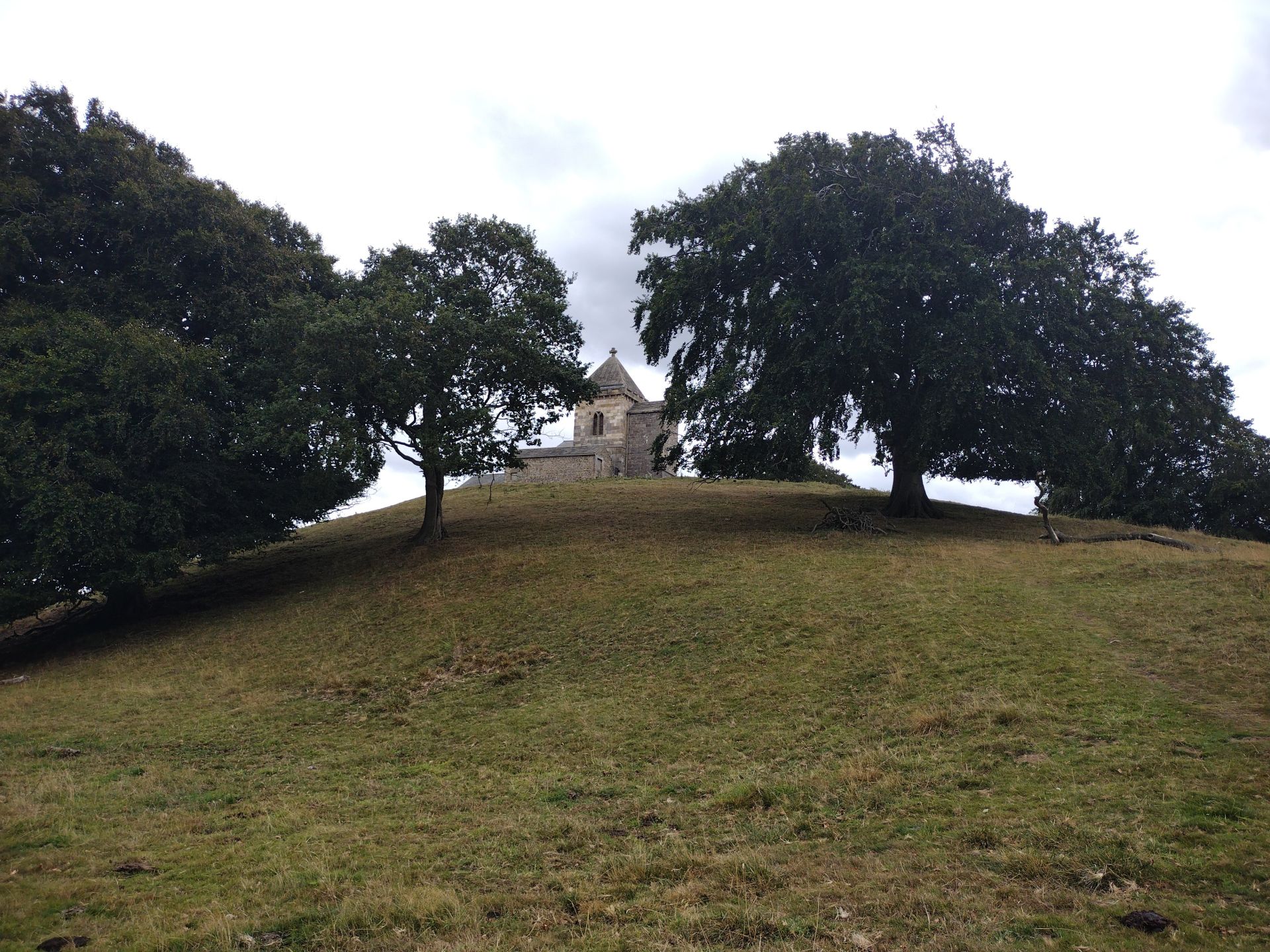 How Hill Tower, a folly looking like a chapel on a hill-top with trees around