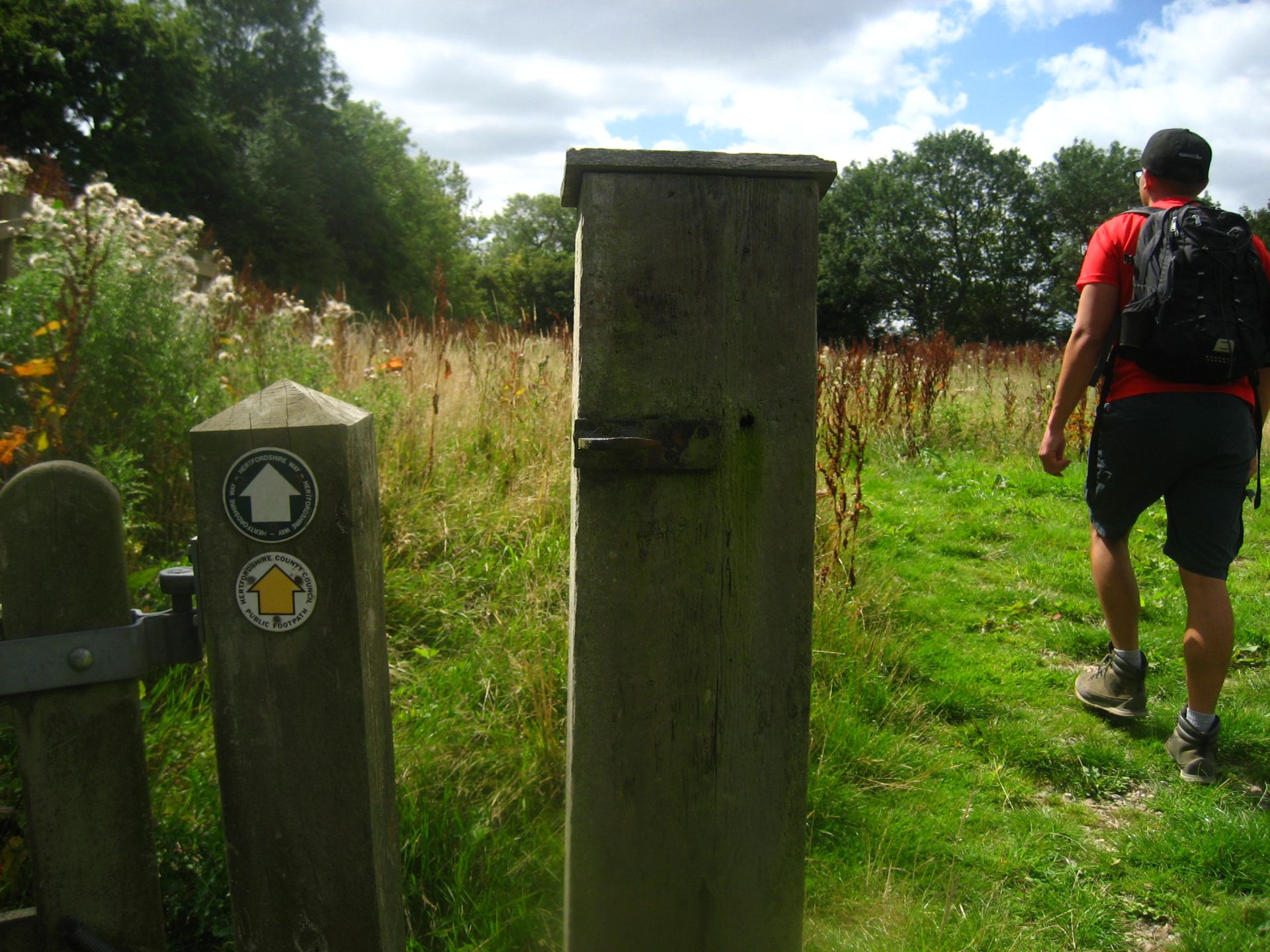 A waymarker and hiker