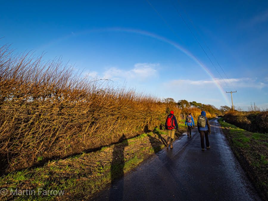 rainbow, ramblers walking on road