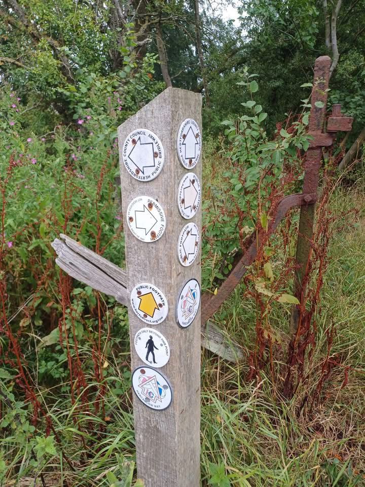 Post with footpath signs
