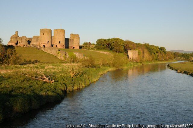 The River Clwyd at Rhuddlan, Denbighshire, with Rhuddlan Castle illuminated by sunlight in the background 