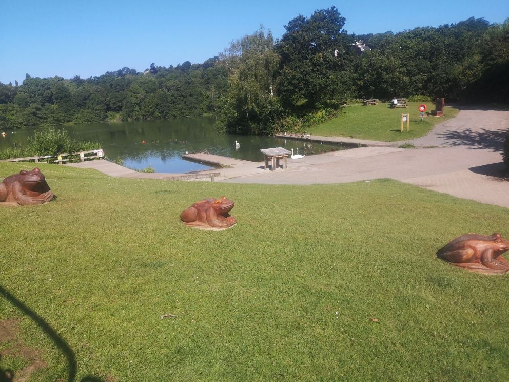 Decoy Lake with wooden frog sculptures in the foreground