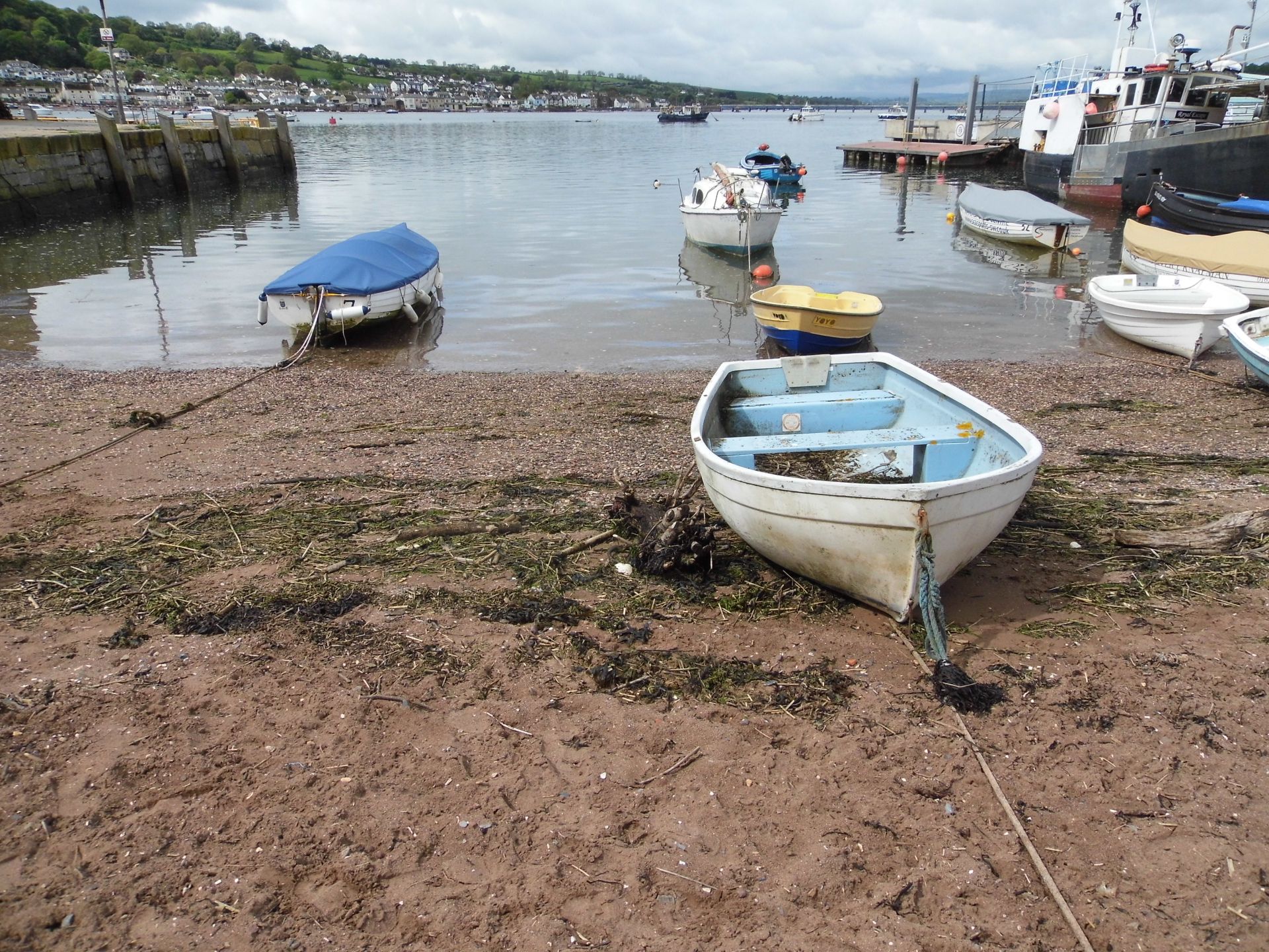 A photo of Teignmouth beach with boats resting on the sand