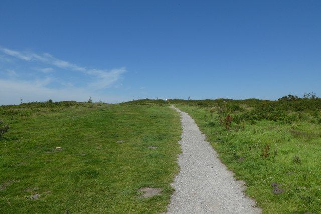 Gravel footpath bordered by grassland extending into the distance towards the viewpoint at Waun-y-Llyn Country Park, Flintshire