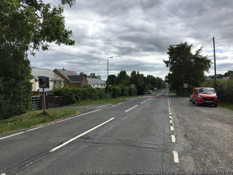 The B5015 road through Clawddnewydd  showing the layby on the outskirts of the village