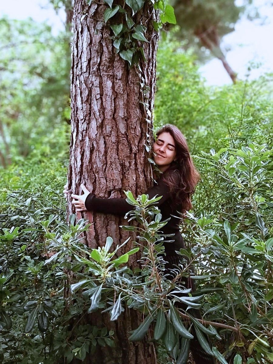 woman hugging tree