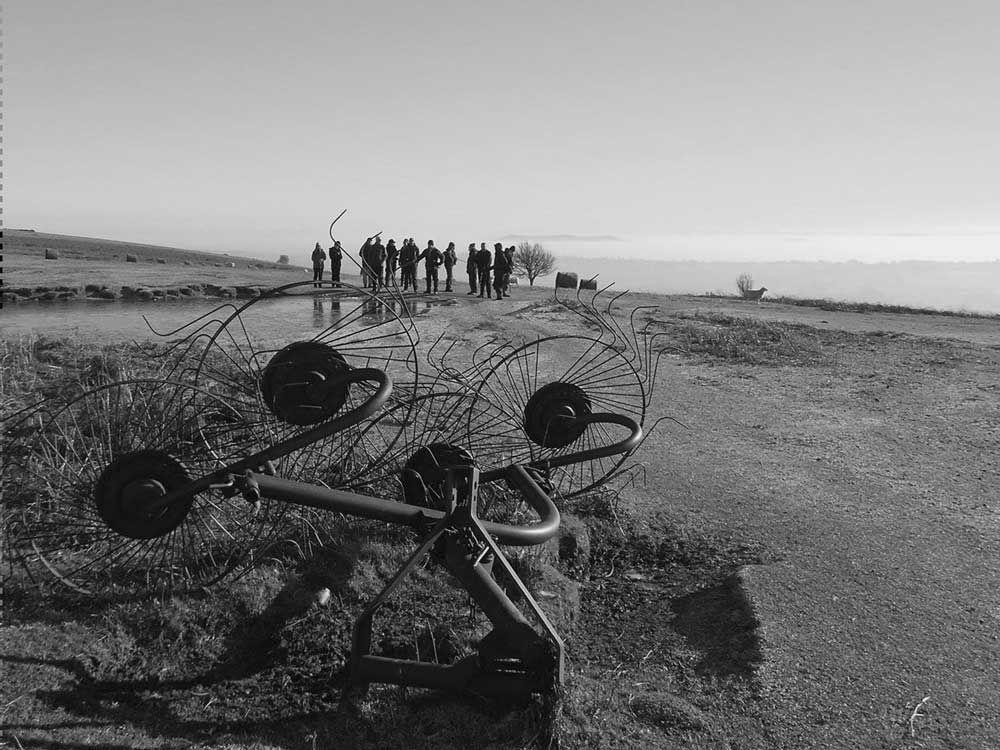 Farm machinery, a pond and some walkers.