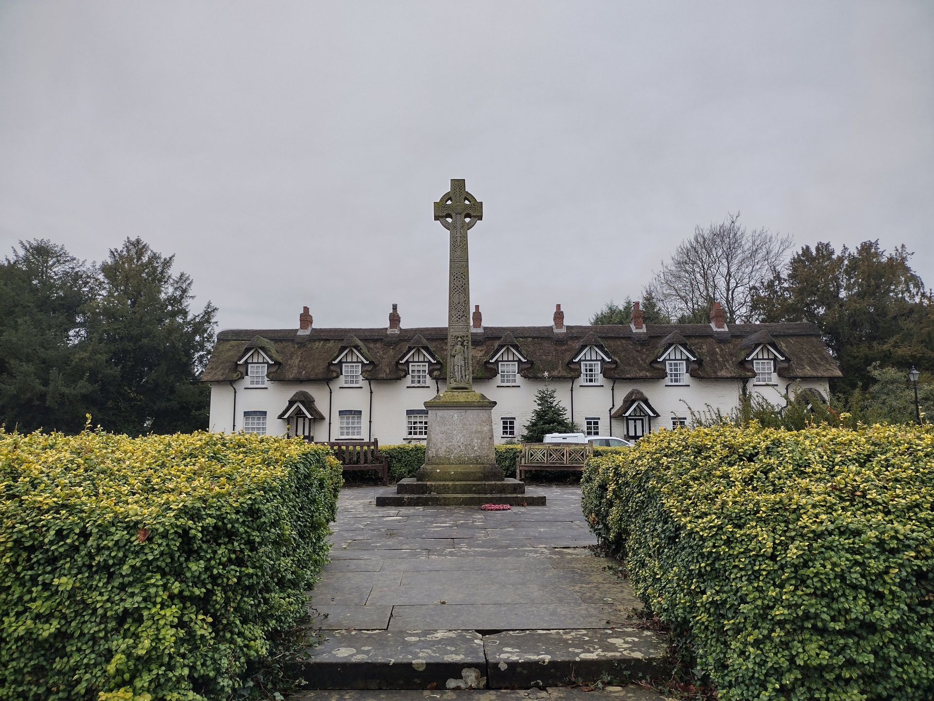 Memorial cross in front of cottages in Warter