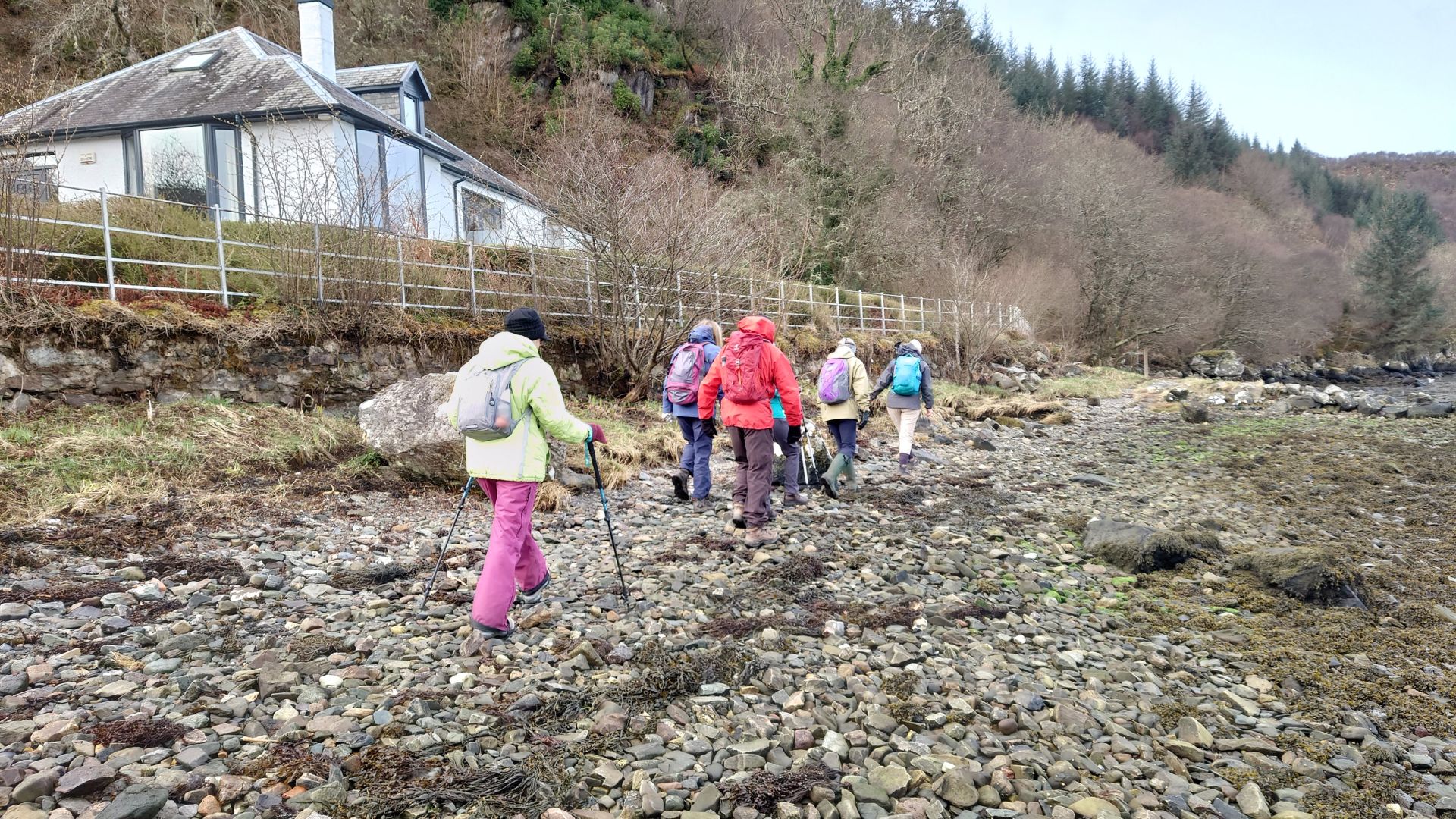 Ramblers walking on stony beach