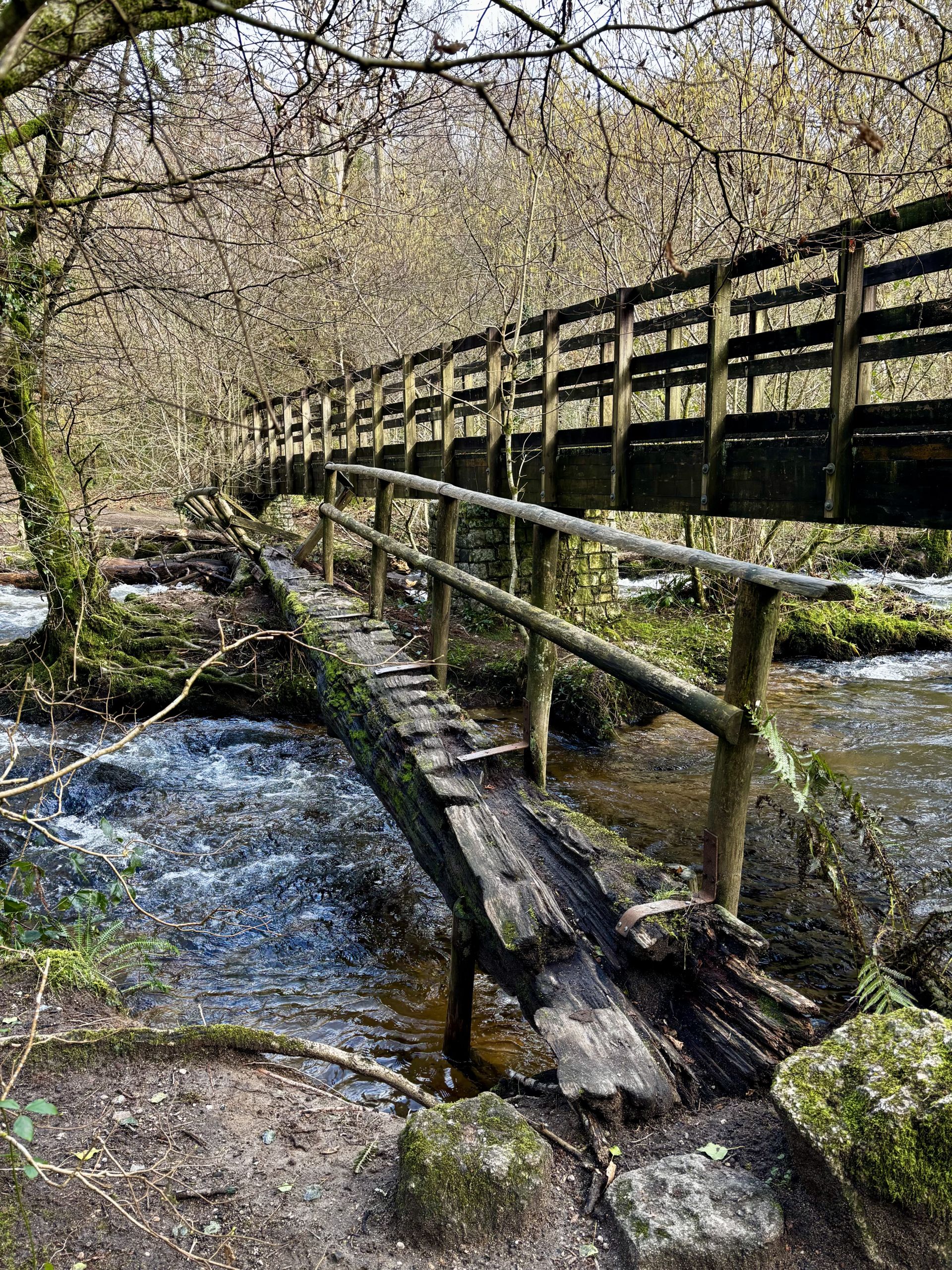 Old Clam Bridge next to new bridge over river Bovey