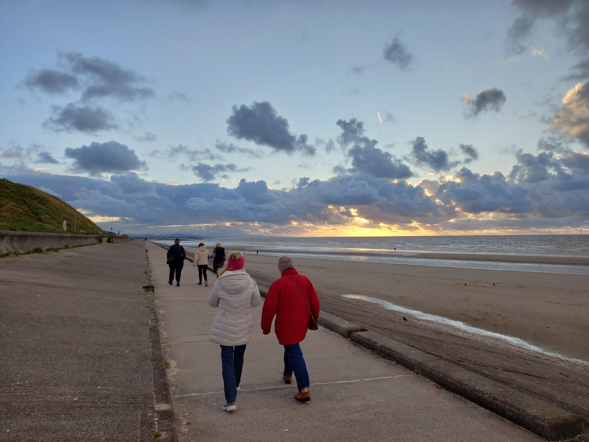 Walkers on the prom at sunset