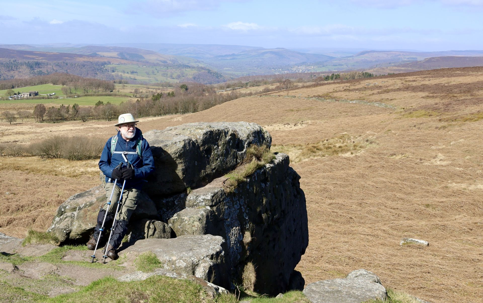 view of a man leaning against a rocky outcrop