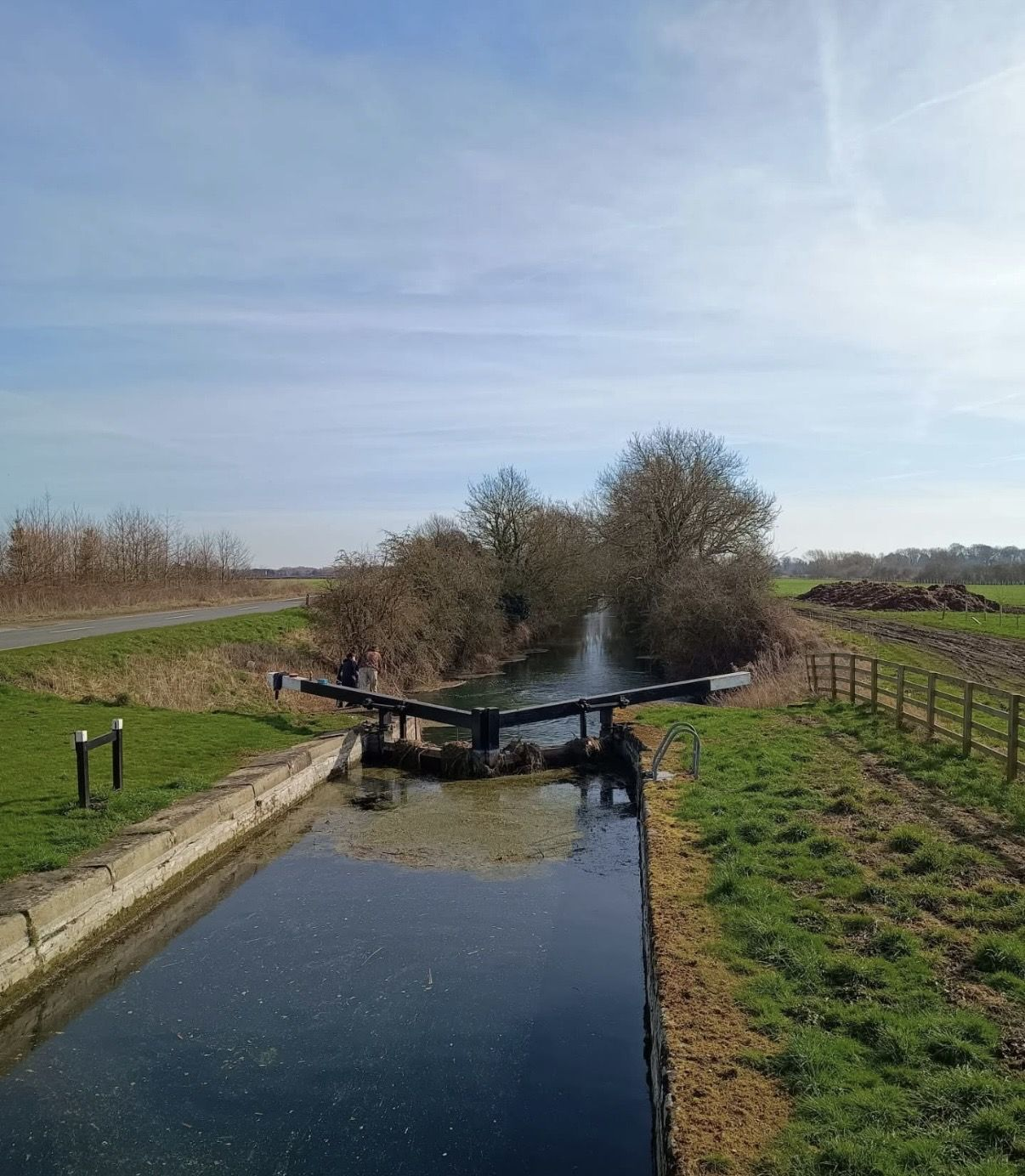 Canal with lock in open countryside