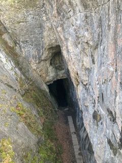 Deep hole in rock to old mine entrance