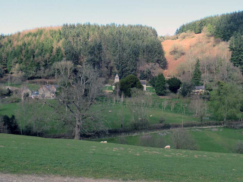 Houses and a church on a distant hillside.