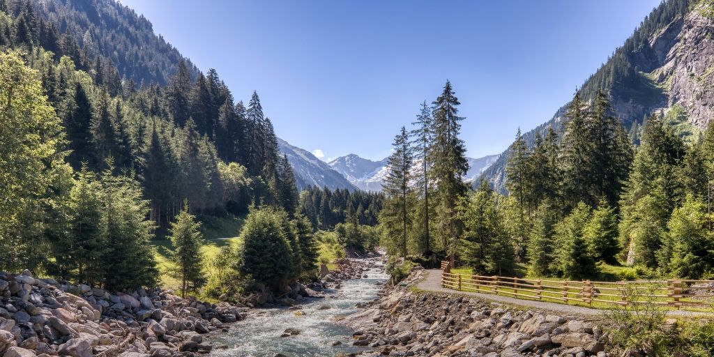 View from a river in an alpine valley on a sunny day