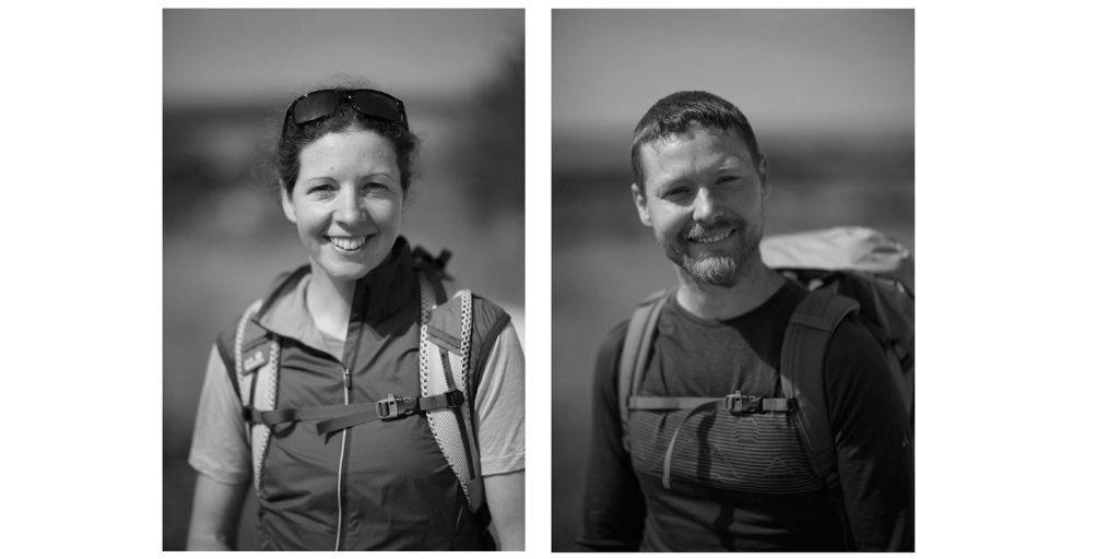A black‑and‑white pair of outdoor portraits showing two hikers wearing backpacks and technical clothing. The hiker on the left wears sunglasses on their head and a short‑sleeve shirt under a zip‑up vest, while the hiker on the right wears a long‑sleeve top with a hiking pack. Both are pictured in an outdoor setting with a soft blurred background.