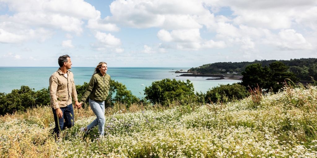 Man and woman walking coastal path