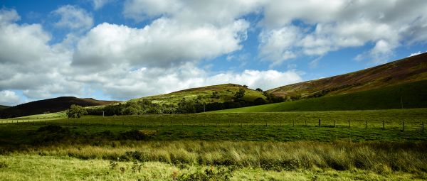 Green fields with green hills in the distance