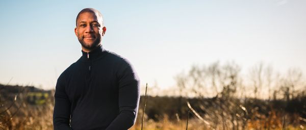 A black man standing outdoors