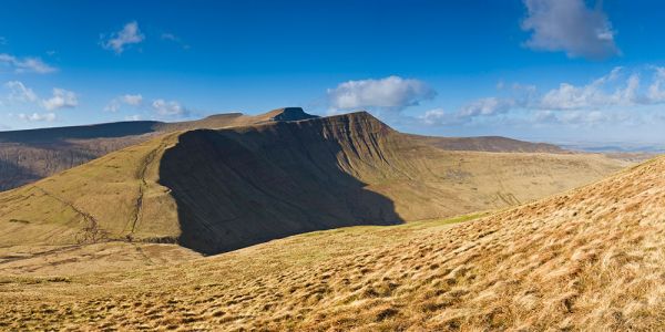 The view out to the high, flat summit of Pen y Fan, with sharp drops on either side. 