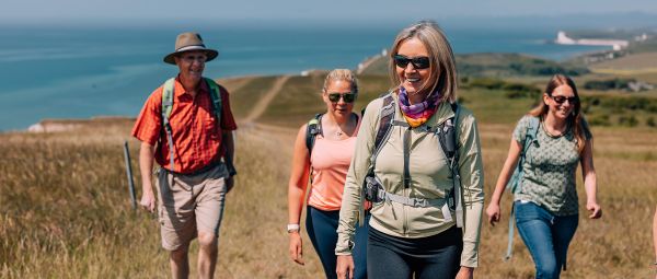 Four walkers on a coastal path