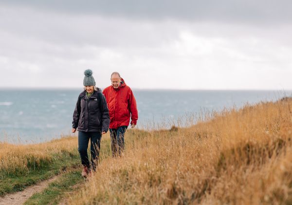 A couple walking by the sea