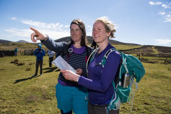 walkers finding directions from a map