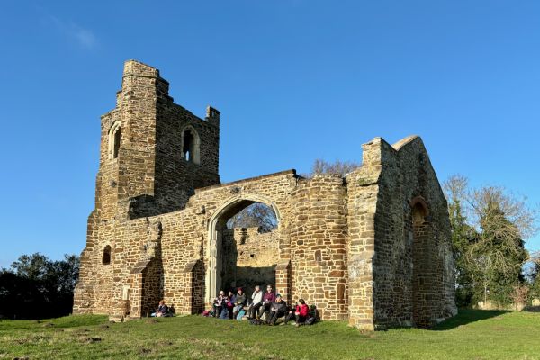 Walkers resting by a church