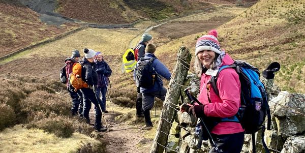 A group of hikers following a path across hilly land
