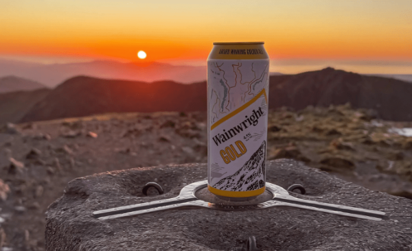 A Wainwright beer can sitting on a mountain rock