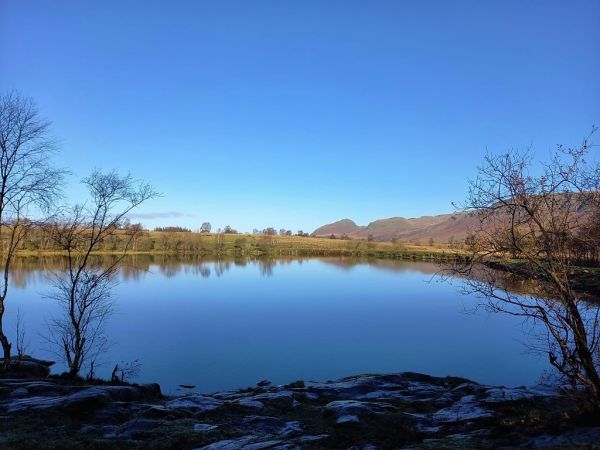 Dumgoyne and Dumfoyne reflected in the still waters of Dumbrock or Ebbie’s (Abies) Loch 