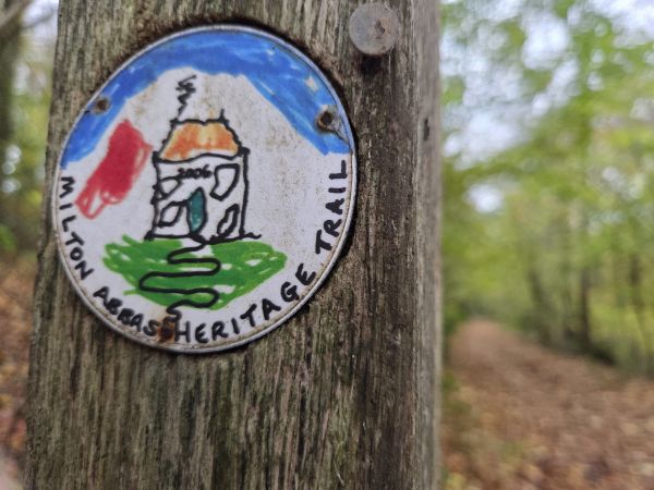 Milton Abbas Heritage Trail plaque on wooden post