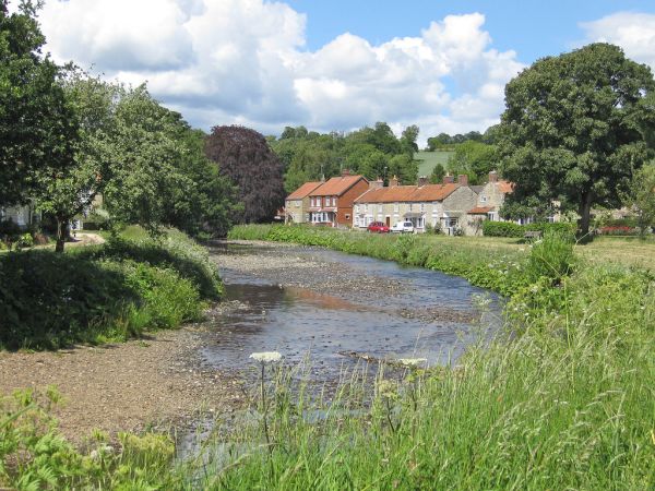 River running through a village green (© Pauline E}