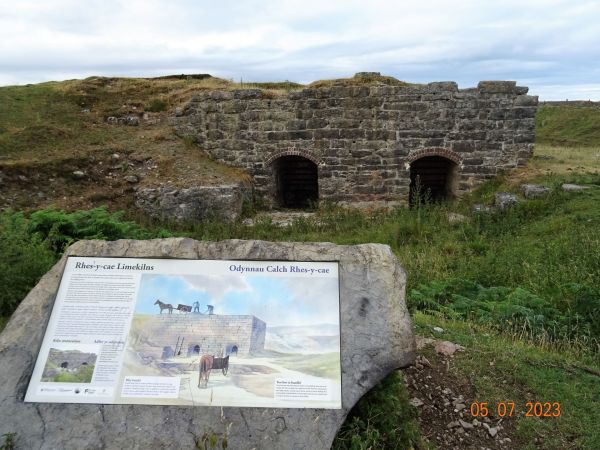 A set of lime kilns with an information board in front at Rhes-y-Cae, Halkyn Mountain