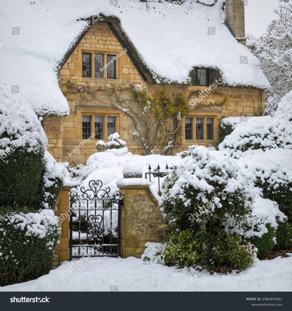 An old Oxfordshire house and garden covered in snow.