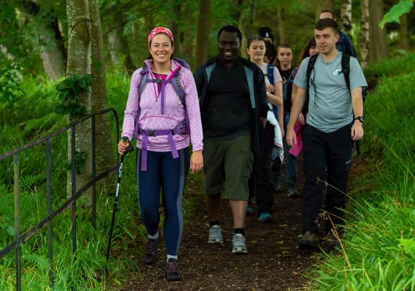 A group of Ramblers walking along a wooded path