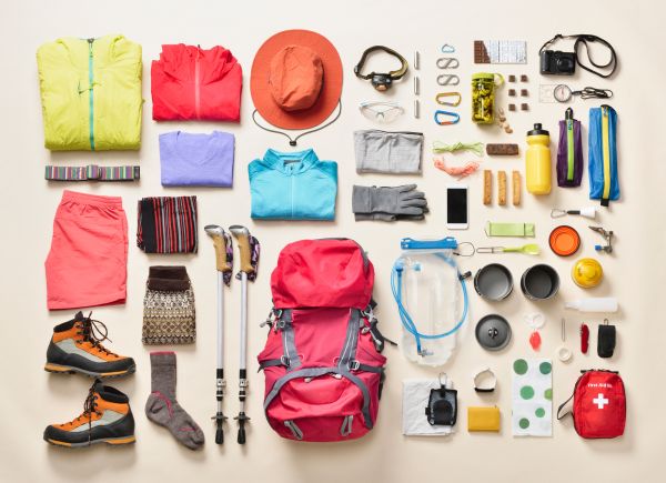 Mountain climbing supplies for women organized in knolling arrangement