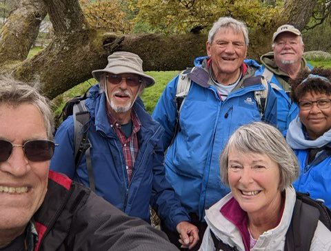 A group of people outdoors, smiling at the camera