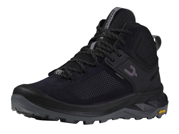 A dark blue mid‑cut hiking boot with black overlays, durable mesh panels, and sturdy lacing hardware. It has a cushioned midsole, Vibram outsole with deep lugs, and Ayacucho branding on the side.