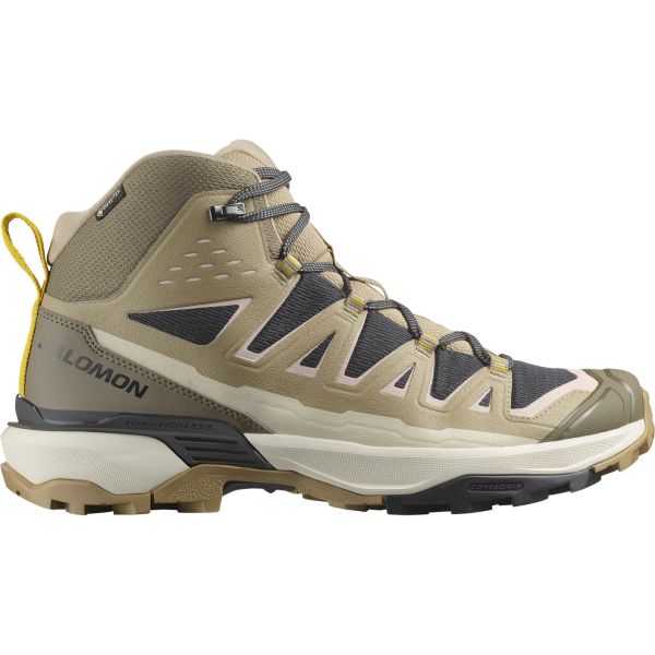 A beige and black mid‑cut hiking boot with breathable mesh panels, structured side overlays, and a reinforced toe. Features include a padded ankle collar, sturdy lace loops, and a grippy Contagrip outsole, with Salomon branding on the side.