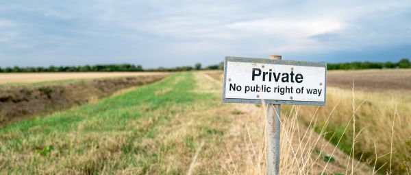 Shallow focus of a No Public Right of Way sign seen on farmland. Located near a public footpath, to help stop stray walkers accessing pricing farmland.