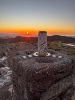 a wainwright beer can on a mountain rock