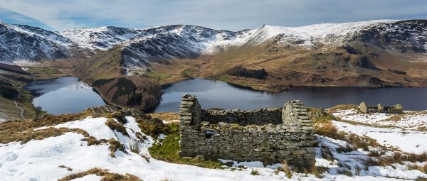 A panoramic view of Haweswater and the surrounding fells in winter with snow, including High Street, in the Lake District, Cumbria, England