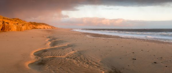 Winterton beach and sand dunes under moody skies in Norfolk, February