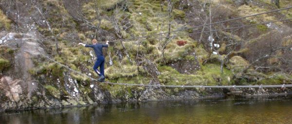 Colin crossing a wire bridge at Steall Falls in Glen Nevis