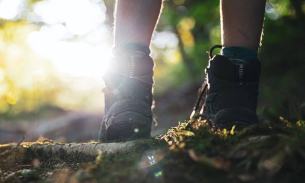 A pair of walking boots, walking at ground level